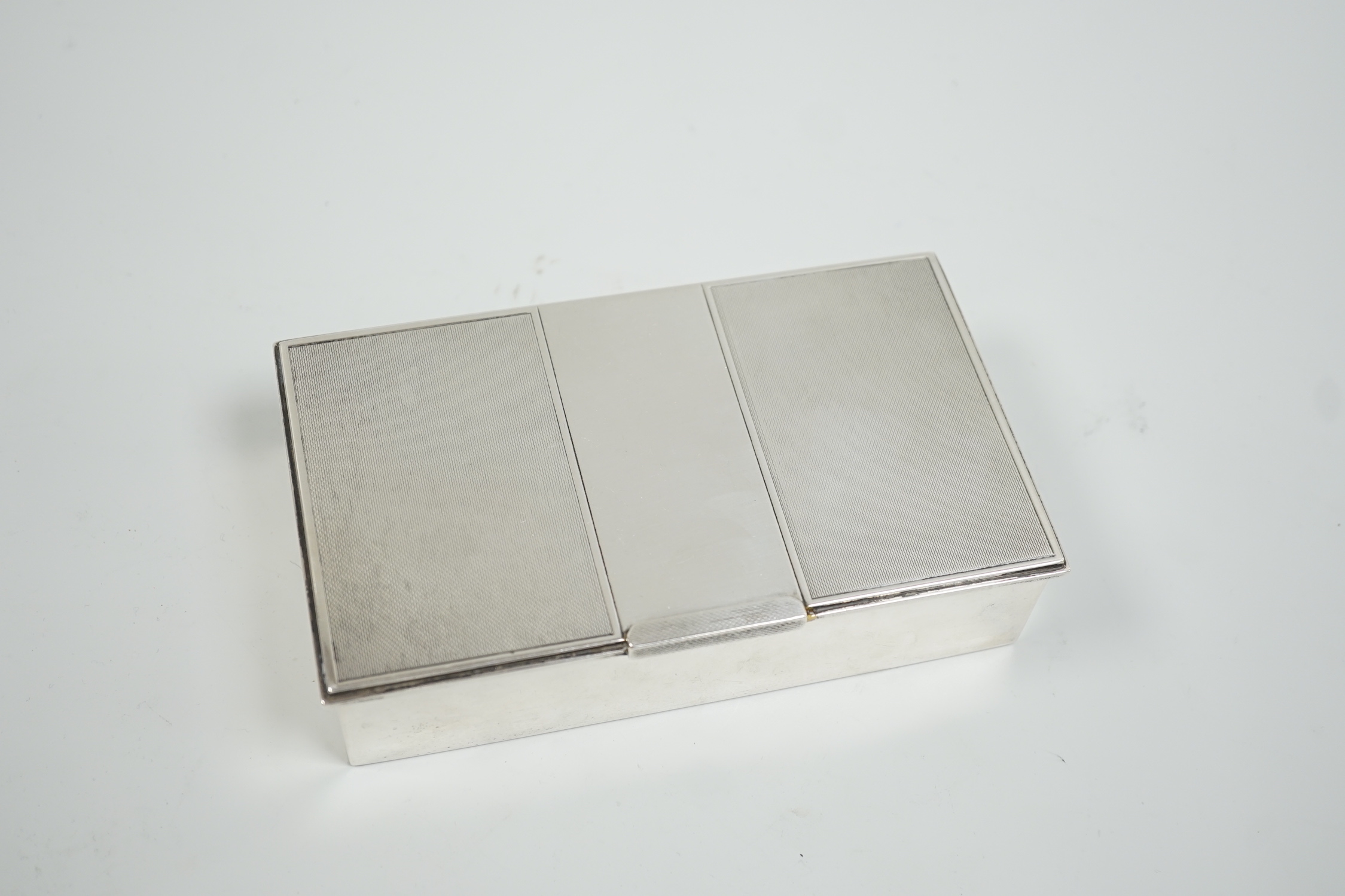 A George VI part engine turned silver mounted cigarette box, London, 1951, 16.5cm.